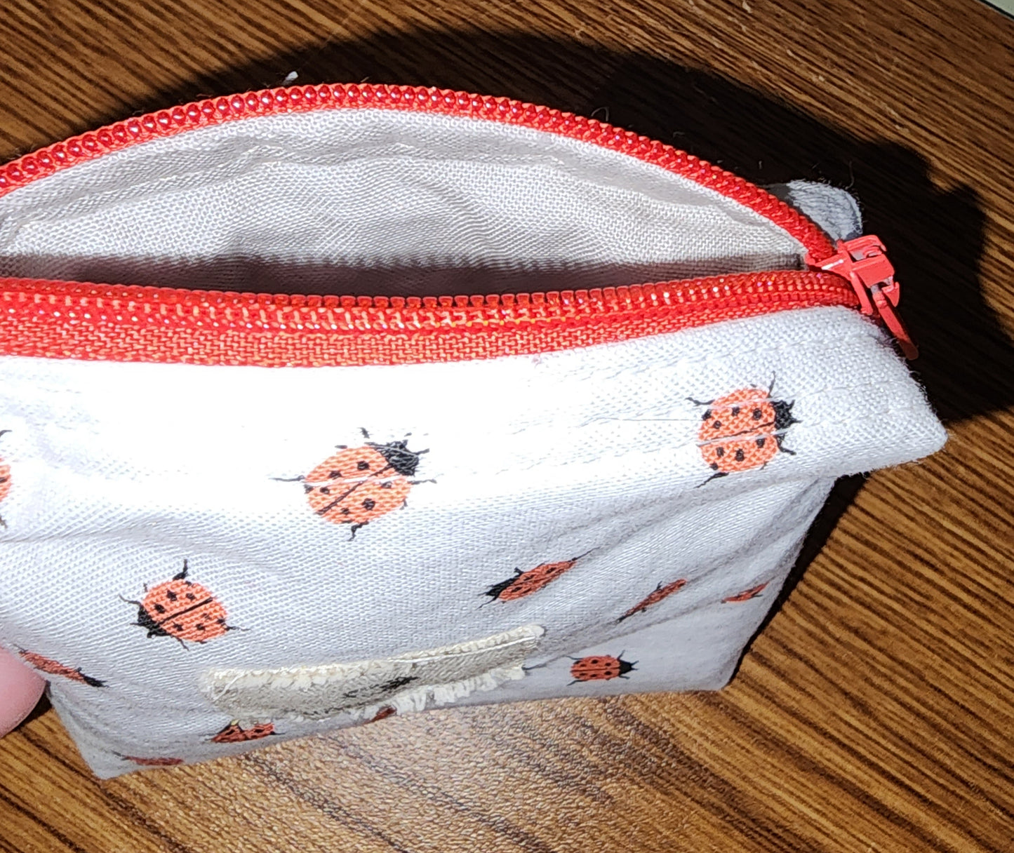 Small Coin Purse: Ear Bud Case: cute ladybugs on a white backing with a red top zipper and white lining