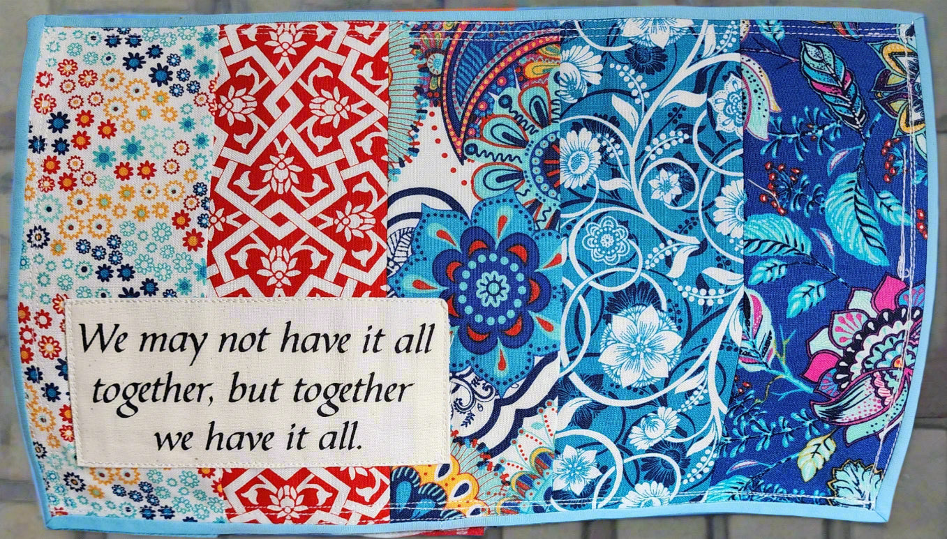 quilted mats in multi-colored cheerful primary colors. We May Not Have It All Together, But Together We Have It All