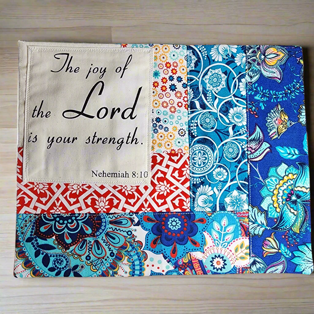 beautiful quilted snack mat/mug rug in patterned primary colors. Scripture on this mat is: The Joy of The Lord your strength. Nehemiah 8:10