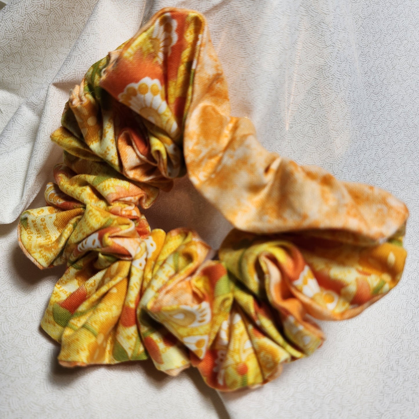 Two-sided multi-colored orange swirl/yellow patterned. hand-crafted, great for medium to thick hair. these will not break your hair. also great for fashionable wristlets'