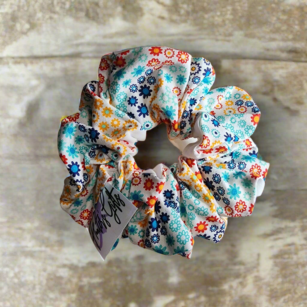 Scrunchies' /Ponytail Holder: two sided solid white on back and multi-colored geometric floral pattern on other side. hair ties will not break your hair. also great for fashionable wristbands