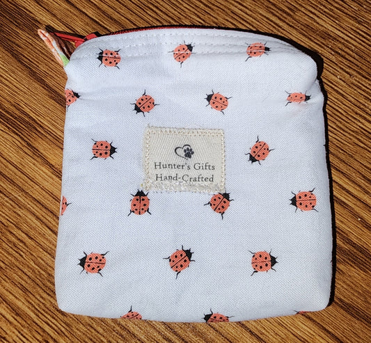 Small Coin Purse: Ear Bud Case: cute ladybugs on a white backing with a red top zipper and white lining
