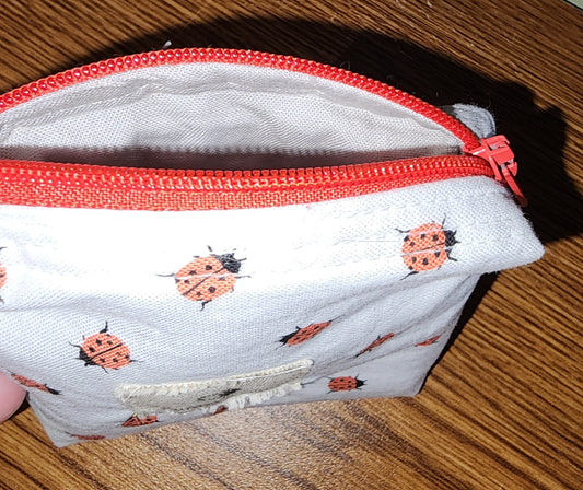 Small Coin Purse: Ear Bud Case: cute ladybugs on a white backing with a red top zipper and white lining