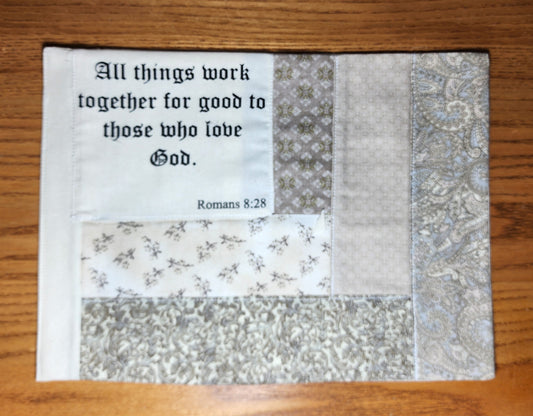 Hand-crafted Snack Mat/Mug Rug Romans 8:28 "All things work together for good to those who love God" quilted mat in patterned beige tones.