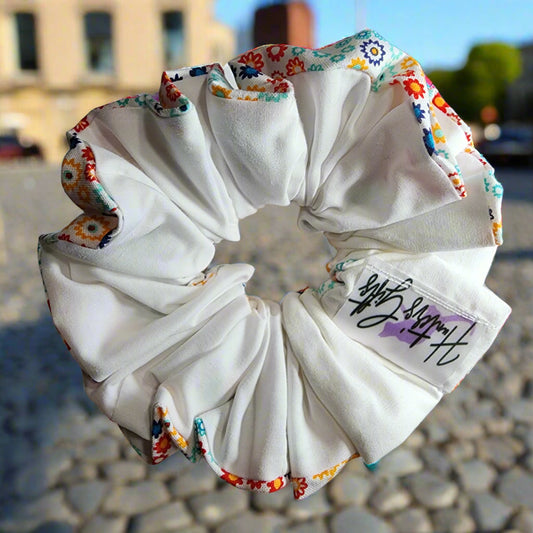 Scrunchies' /Ponytail Holder:  two sided solid white on back and multi-colored  geometric floral pattern on other side. hair ties will not break your hair. also great for fashionable wristbands 