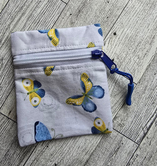 Small:  White Front Zip :  white with blue and yellow butterflies: great size for credit cards, coins, ear buds, folded money, ChapSticks :  Great for tagging to keys