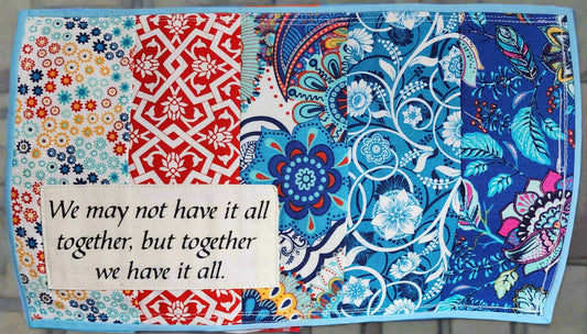 quilted mats in multi-colored cheerful primary colors.  We May Not Have It All Together, But Together We Have It All
