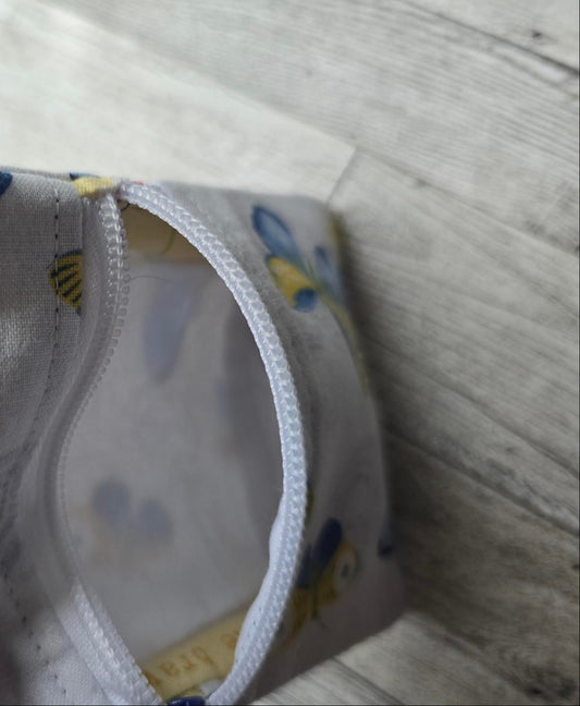 Small:  White Front Zip :  white with blue and yellow butterflies: great size for credit cards, coins, ear buds, folded money, ChapSticks :  Great for tagging to keys