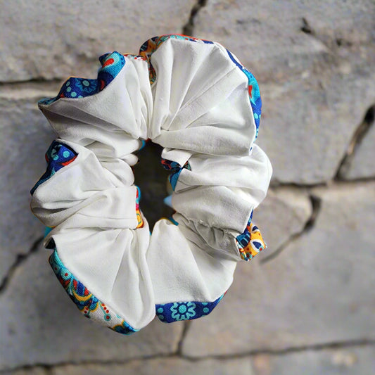 Scrunchie: two tone  front multi-colored blue/yellow/red patterned: back is white hand-crafted , so many uses, hair scrunchie or wristlet.