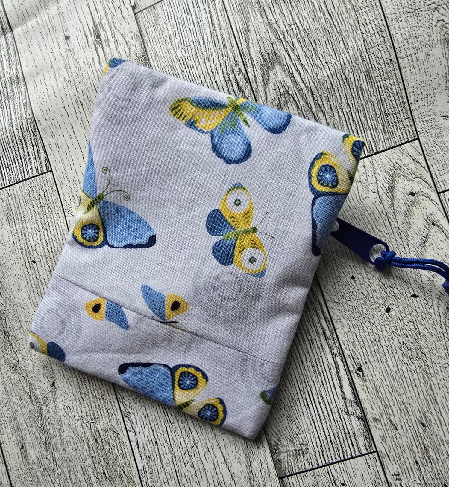 Small:  White Front Zip :  white with blue and yellow butterflies: great size for credit cards, coins, ear buds, folded money, ChapSticks :  Great for tagging to keys